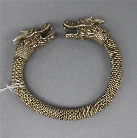 A white metal Chinese dragon bangle